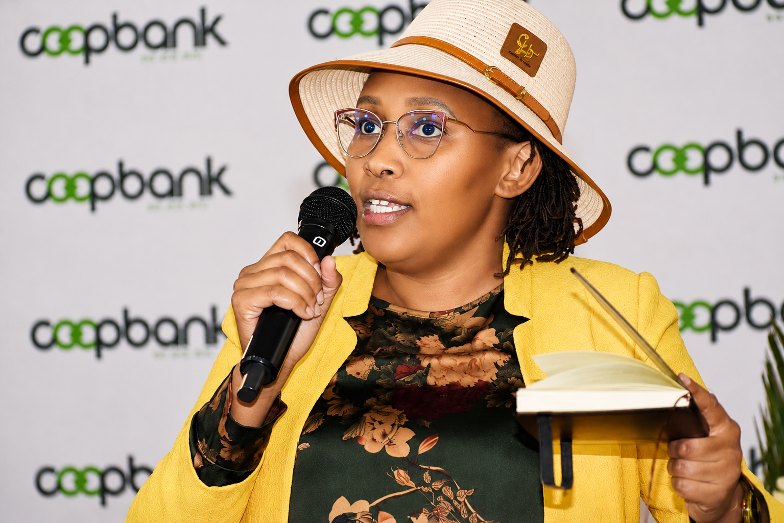 Wanjiru Kibe speaking into a microphone at the Co-operative Bank Water Sector Business Forum